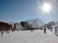 a group of people skiing on a snow covered slope at Studio Pegase Phenix-44 by Interhome in Le Corbier