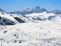 a snow covered mountain with people skiing on a ski slope at Apartment Les Glaciers by Interhome in Val Thorens