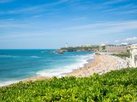a beach with people on the sand and the ocean at Apartment Carlton-1 by Interhome in Biarritz