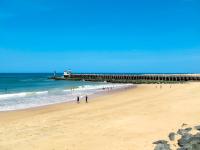 a group of people on a beach with a pier at Apartment Les Berges Landaises-1 by Interhome in Soorts-Hossegor