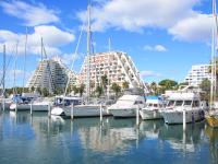 a group of boats docked in a marina with buildings at Apartment Marin&#39;Land by Interhome in La Grande Motte