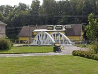 a white bridge in front of a building at Penzion U Halířů in Mladé Buky