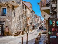 a street in an old town with buildings at Apartment Stanatura-4 by Interhome in Porto-Vecchio