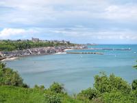 a view of a beach with a pier in the water at Holiday Home La Vallée by Interhome in Cancale