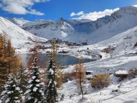 a town on a snowy mountain with a lake at Studio Rond Point des Pistes-19 by Interhome in Tignes