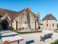 a stone church with a bench in front of it at Holiday Home Blaue Hortensie - SZN100 by Interhome in Sizun