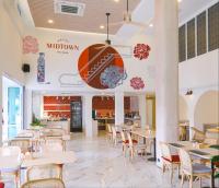 a dining area with tables and chairs in a restaurant at Hotel Midtown Ratsada in Phuket Town