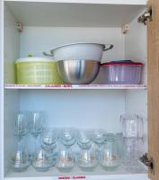 a cabinet filled with glasses and a bowl on top at La Perle du Cap in Case-Pilote