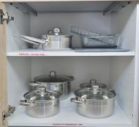four pots and pans on a shelf in a kitchen at La Perle du Cap in Case-Pilote