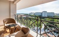 a balcony with chairs and a view of the city at Vinpearl Resort & Spa Phu Quoc in Phú Quốc