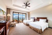 a hotel room with two beds and a balcony at Vinpearl Resort & Spa Phu Quoc in Phú Quốc