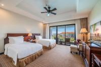 a hotel room with two beds and a balcony at Vinpearl Resort & Spa Phu Quoc in Phú Quốc