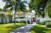 a white house with palm trees and a walkway at Vinpearl Resort & Spa Phu Quoc in Phú Quốc
