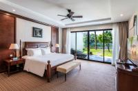 a bedroom with a bed and a large window at Vinpearl Resort & Spa Phu Quoc in Phú Quốc