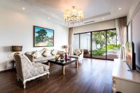 a living room with a couch and a table at Vinpearl Resort & Spa Phu Quoc in Phú Quốc