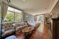 a large living room with a bed and a couch at Ming Ging Farm in Ren&#39;ai