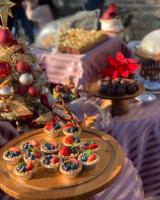 a table topped with cupcakes and fruit on a tray at Ming Ging Farm in Ren&#39;ai