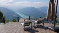 two chairs and an umbrella on a deck with a view at Ming Ging Farm in Ren&#39;ai