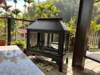 a black lantern sitting on a patio with a table at Zhong Ming Ju Taoyi Fang in Fanlu
