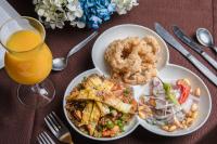 a table with two plates of food and a glass of orange juice at Hotel Miramar in Lima