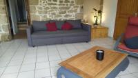 a living room with a couch and a coffee table at Gite la Péraie - Le Roseau in Treize-Vents