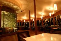 a restaurant with a table and chairs and plants on the wall at Ying Shih Guest House in Datong