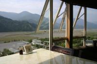 a room with a table with a view of mountains at Ying Shih Guest House in Datong