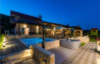 a house with a swimming pool at night at Stunning Home In Siveric With 5 Bedrooms, Jacuzzi And Outdoor Swimming Pool in Siverić