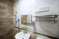 a bathroom with a sink and a mirror and towels at Lantian Baiyun in Hualien City