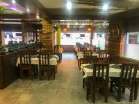 un ristorante con tavoli e sedie in una stanza di Hotel Lotus Grand Pvt Ltd a Kathmandu