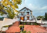 ein Haus mit einer gepflasterten Auffahrt davor in der Unterkunft NHỚ House IV in Da Lat