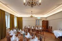 a dining room with tables and chairs and a chandelier at Linde Heiden Swiss Quality Hotel in Heiden