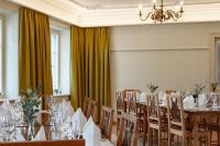 a conference room with a table and chairs and a chandelier at Linde Heiden Swiss Quality Hotel in Heiden