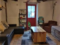 a living room with a couch and a coffee table at Maison familiale, 15couchages, de charme au cœur de la Bretagne - 20 min de Vannes in Lizio