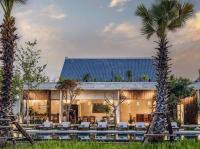 a resort with a pool and palm trees at Le Chanthou Boutique in Siem Reap