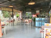 a restaurant with tables and chairs and a bar at INZOZI AFRICA HOUSE B&B-Gishushu in Kigali
