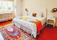 a bedroom with a bed and a red rug at Villa Saint Kirio - piscine et spa in Morlaix