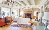 a living room with a fireplace and white furniture at Villa Saint Kirio - piscine et spa in Morlaix