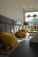 a couch with yellow pillows on it in a room at Novotel Poznań Malta in Poznań