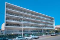 a large building with cars parked in front of it at IMMOGROOM - Renovated apartment - Terrace - AC in Cannes