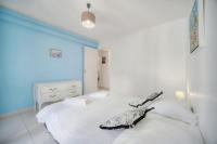 a white bed with two pillows on top of it at IMMOGROOM - Renovated apartment - Terrace - AC in Cannes