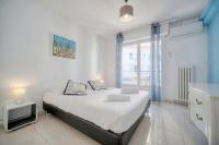 a bedroom with a bed with a tv and a window at IMMOGROOM - Renovated apartment - Terrace - AC in Cannes