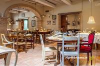 a restaurant with wooden tables and chairs in a room at B&B Al Felcino in Fabro