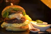 a hamburger with cheese and sauce on a table at B&B Al Felcino in Fabro
