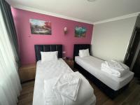 Postel nebo postele na pokoji v ubytování MİRHAN HOTEL