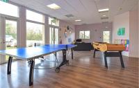 a ping pong table in a room with a ping pong ball at Awesome Apartment In quemauville With Outdoor Swimming Pool, Heated Swimming Pool And 1 Bedrooms in Équemauville