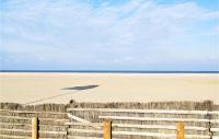 a fence on the beach with the ocean in the background at Awesome Apartment In quemauville With Outdoor Swimming Pool, Heated Swimming Pool And 1 Bedrooms in Équemauville