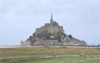 a castle on top of an island in the water at Awesome Apartment In quemauville With Outdoor Swimming Pool, Heated Swimming Pool And 1 Bedrooms in Équemauville