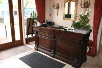 a room with a wooden counter with a mirror at Hôtel Saint Alban in Saint-Maur-des-Fossés