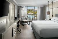 a hotel room with a bed and a desk and a chair at Orlando World Center Marriott in Orlando